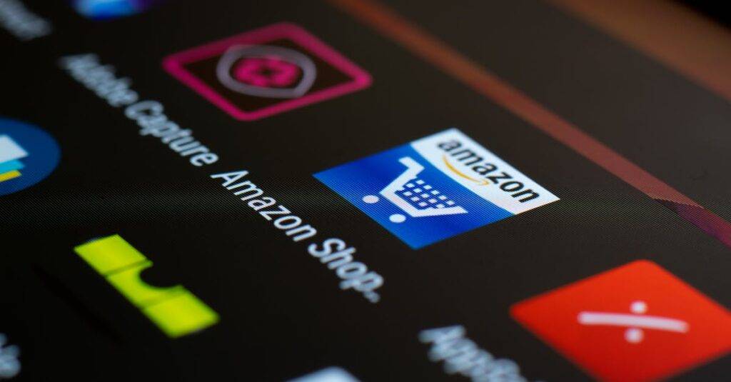 Amazon shopping app icon on a smartphone screen. Ideal for online shopping and technology themes.